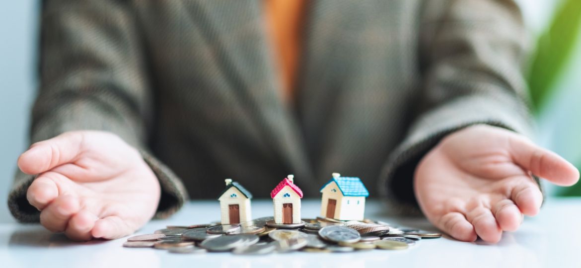 houses on coin pile to showcase real estate investments made with hard money loans